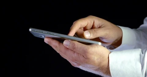 Man is tapping touch screen of smartphone, extending pictures and swiping 库存影片 116758383