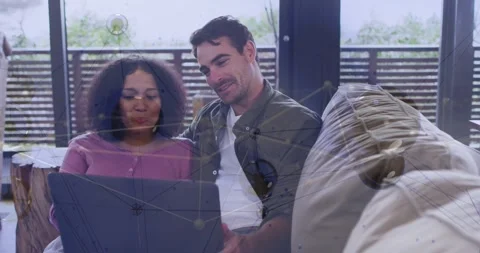 Man tapping white mouse, woman holding laptop, reviewing tech data as network Stock Footage 332296429