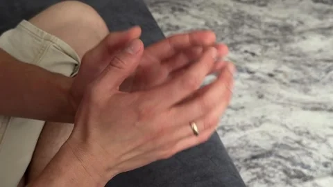 Man taps the knuckles of his fingers together in a rhythmic, repetitive motion. Stock Footage 336977891