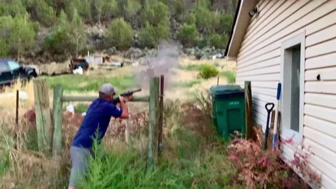 Man target shooting rifle Stock Footage 197394755