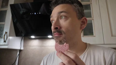 Man tastes salami Video stock 321776304