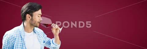 Man tasting wine against maroon background Stock Photos