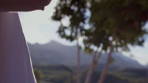 Man tasting wine and talking, reflection of sun rays in glass, nature background Stock Footage 318292052