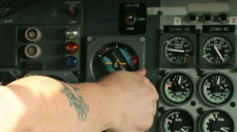 Man with tattoo operating engine controls in aircraft 01 Stock Footage 42513573