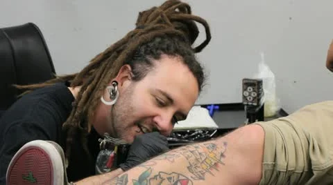Man tattooing a leg Stock Footage 12290338