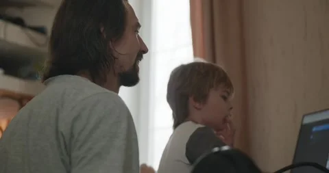 Man Teaches Kid Boy to Play Chess on Computer. 4K 10-bit Stock Footage 320170199