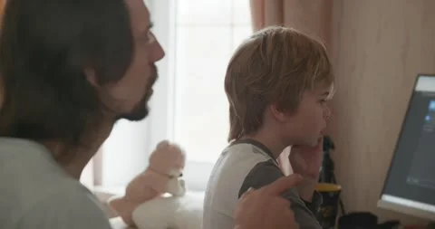 Man Teaches Kid Boy to Play Chess on Computer. 4K 10-bit Stock Footage 320170203