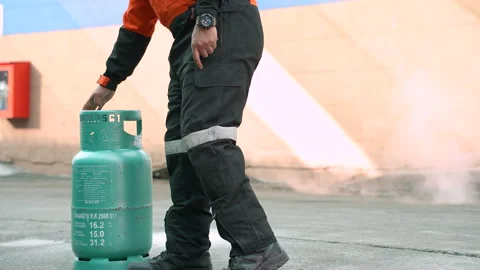 Man teaches or training how to close fire from LPG cooking gas tanks. Stock Footage 223882945