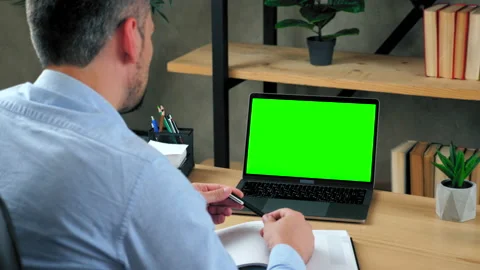 Man teaches students by online remote webcam video call with green screen laptop Video stock 141608176