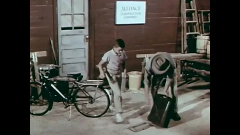 A man teaches a young boy about blasting caps and dynamite in 1957. Stock Footage 86497096