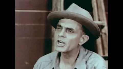 A man teaches a young boy about blasting caps and dynamite in 1957. Stock Footage 86497099