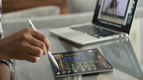 Man teaching an online mathematic class via video call and tablet Stock Footage 128275979