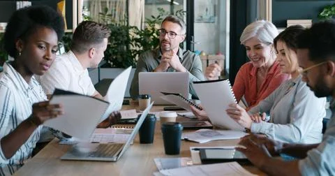 Man, team and discussion for documents at startup for review, planning or l.. Stock Photos