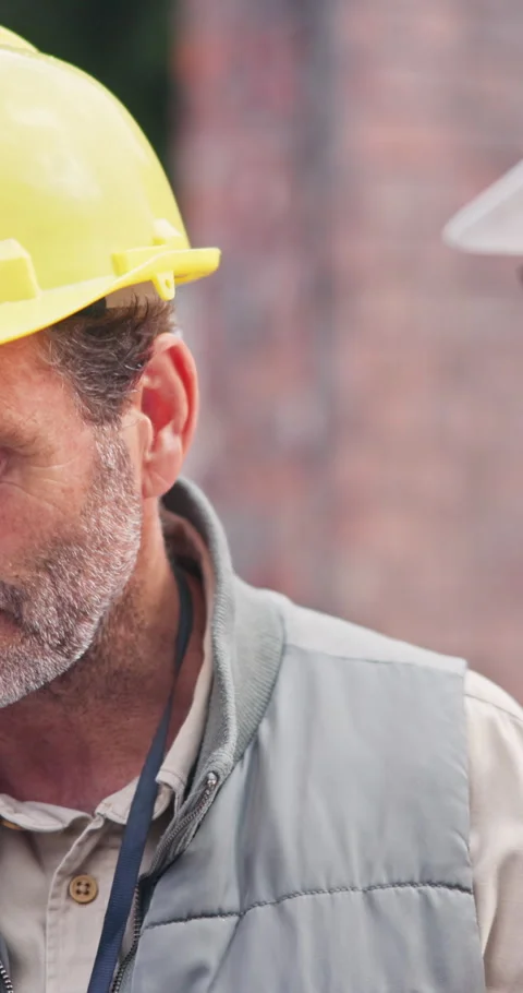 Man, team and discussion on site with construction manager, civil engineering Stock Footage 340958463