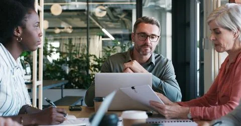 Man, team and laptop with documents in meeting for manuscript revision, new.. Stock Photos