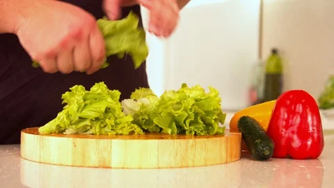 Man tearing lettuce in kitchen Stock-Footage 130057504