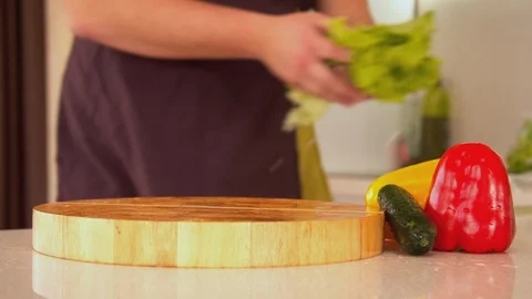 Man tearing lettuce in kitchen Stock Footage 130066419