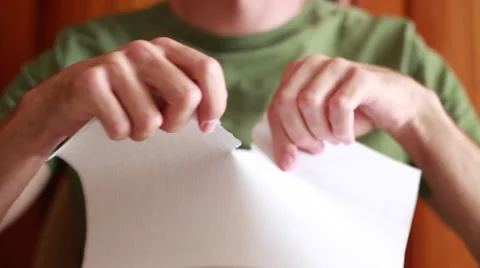 Man tearing a sheet of paper Stock Footage 65370655