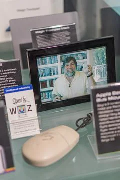 Man at a tech-focused desk, using an Apple computer with webcam Scattered obj Stock Photos