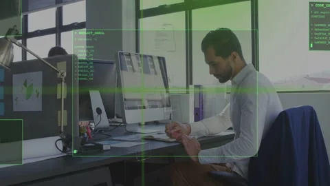 Man in tech office reviewing modules and writing notes while HUD overlay Stock Footage 333062340