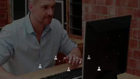 Man in tech office typing and clicking mouse causing digital user icons Stock Footage 309893922