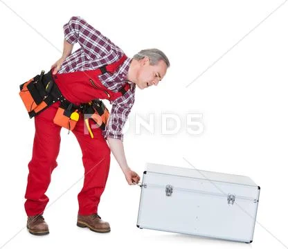 Man technician with back pain lifting metal box Stock Photos