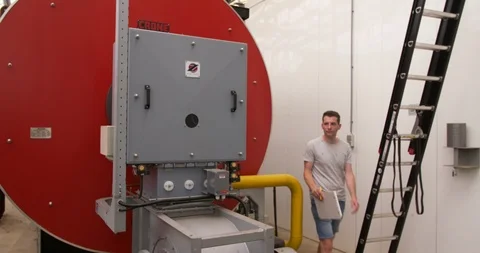 Man technician inspecting industrial climate installation, panning shot Stock Footage 90703485