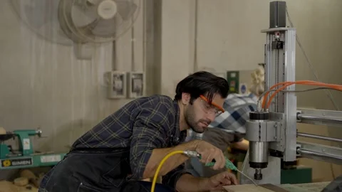 Man technician workshop wearing safety glasses operates machine drill press.. Stock Footage 332446368