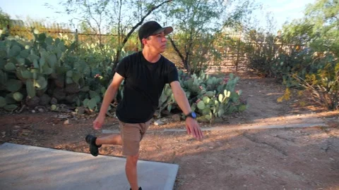 A man at Tee-off in a game of disk golf Stock Footage 247081471