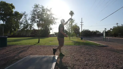 A man teeing-off on a hole in disc golf Stock Footage 246826766