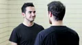 Man tells a unlikely story - couple of friends who laugh and hug HD Footage