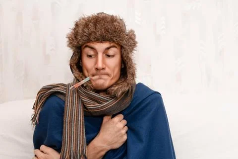 Man with a temperature and flu getting well. Sore throat, cold, influenza. Fotos Stock