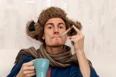 Man with a temperature and flu getting well. Sore throat, cold, influenza. Stock Photos