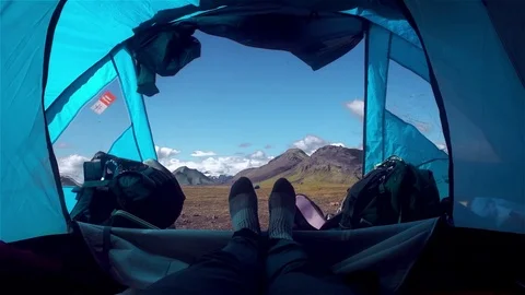 Man in tent with a view of mountains Stock Footage