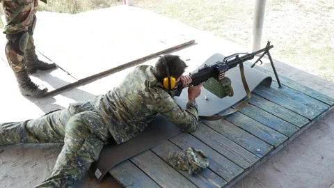 Man terrorist shoots with machine gun enemies targets Stock Footage 145192148
