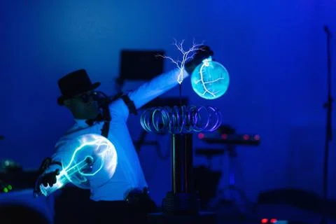 Man on Tesla show lightning. Static electricity. Stock Photos