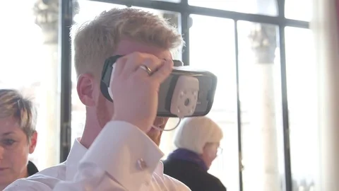 A Man test Virtual Augmented Reality goggles in a museum Stock Footage 73217712