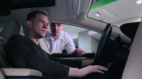 Man testing the dashboard inside the electric car Stock Footage 68191381