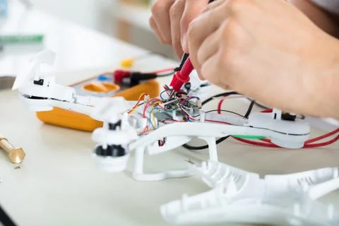 Man Testing Electric Current Of Drone Using Multimeter Tool Stock Photos