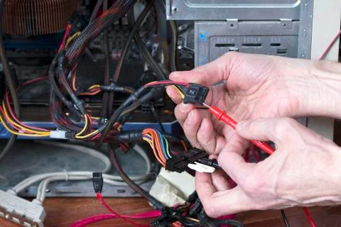 Man is testing the electrical power of personal computer. Computer repair Stock Photos
