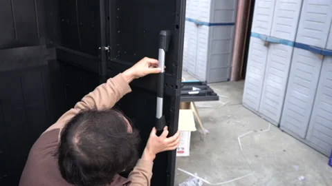 A man testing the handle of a plastic closet door Stock Footage 140751338