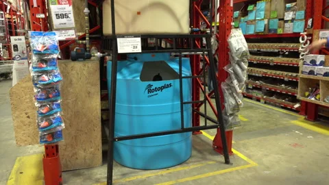 A man testing a metal structure of some home water tanks  Stock Footage 140333216