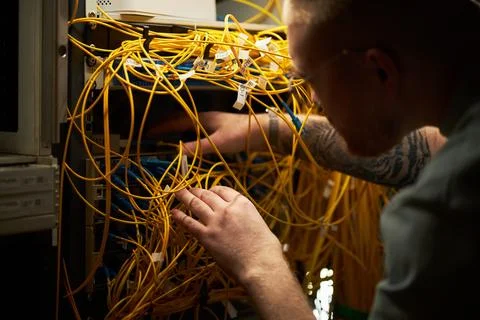 Man Testing Network Cables in Server Room Stock Photos