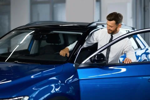 Man testing new car before making purchase at salon Stock Photos