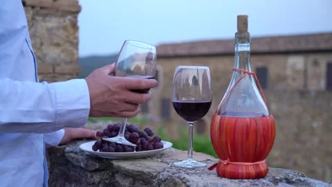 Man testing red wine from the typical chianti wine bottle Stock Footage 244876258