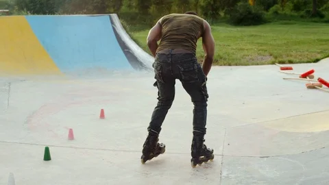 Man Testing rollerblades,in a park. 4k Clip Stock Footage 110824887