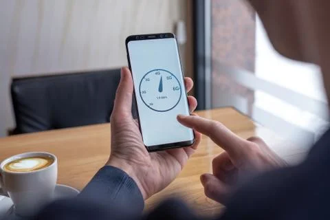 Man testing speed network with mobile phone. Concept of network speed and gen Stock Photos