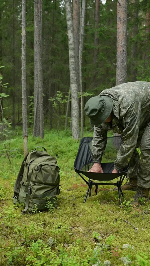 Man testing the stability of a folding chair Stock Footage 340653492