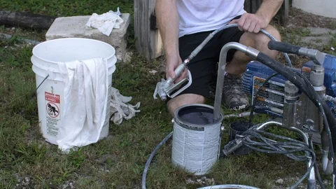 Man Tests Paint Gun Nozzle before Painting House Stock Footage 95484018