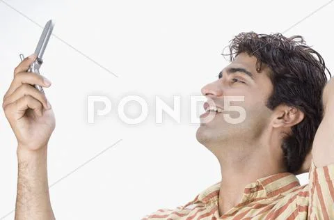 Man text messaging on a mobile phone Stock Photos